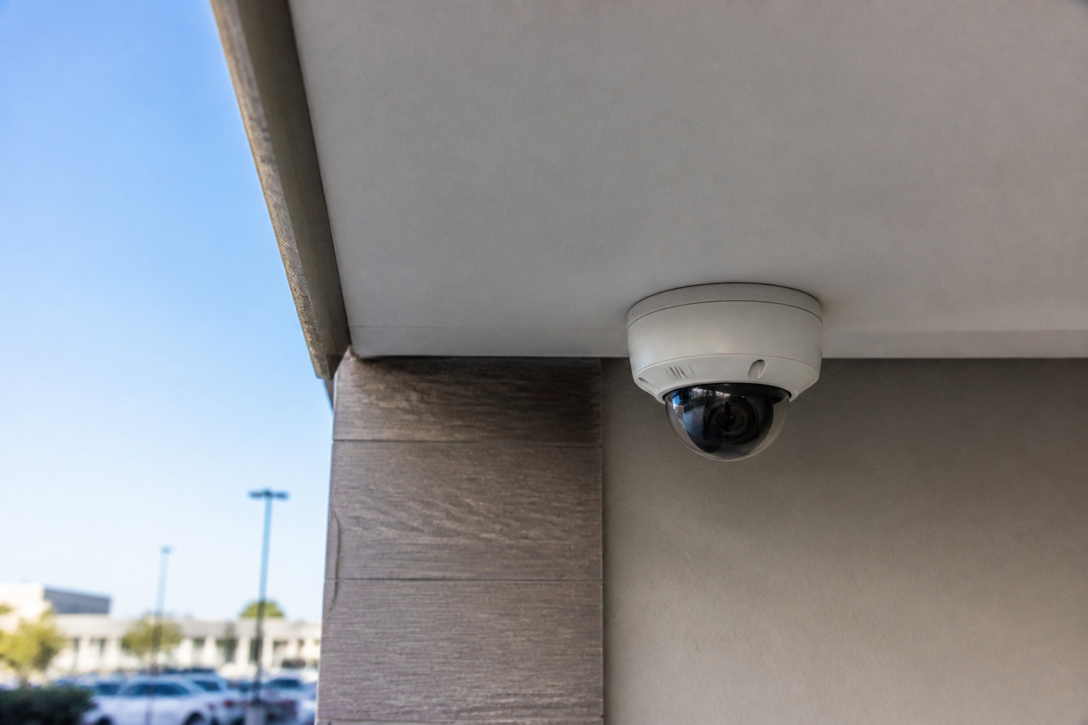IP dome camera installed on a commercial building soffit